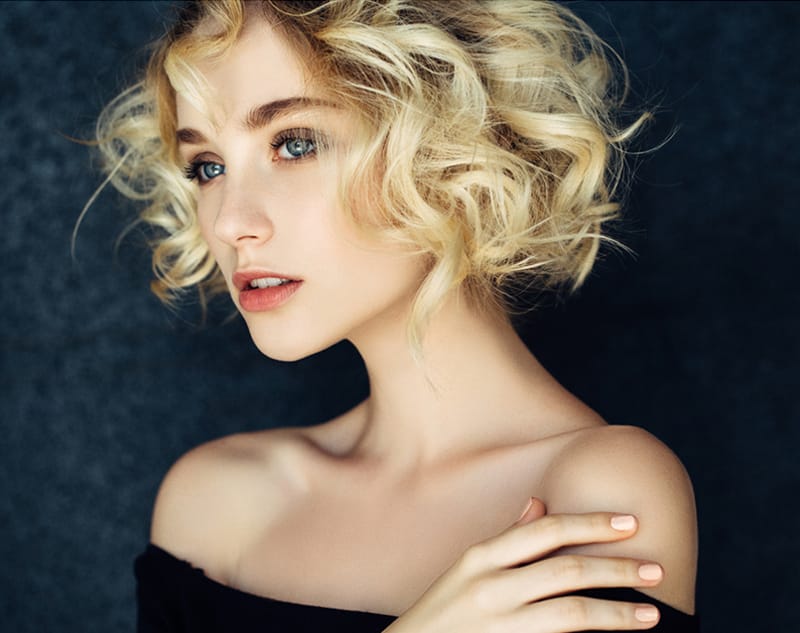 Woman with short blonde curly hair